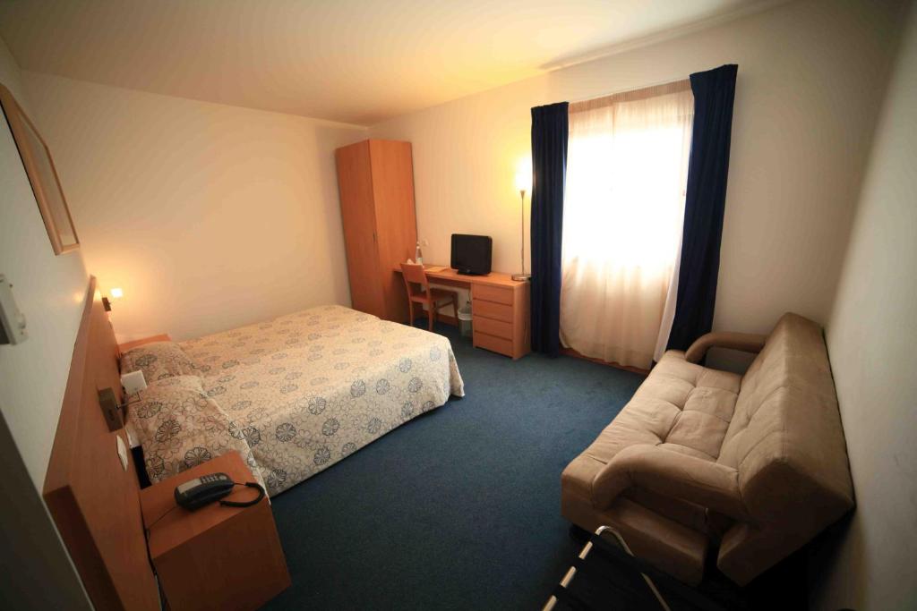 Postel nebo postele na pokoji v ubytování Hotel Matriz