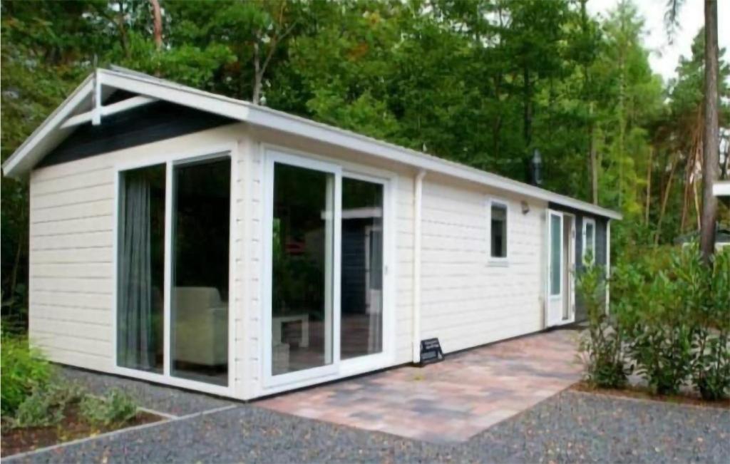 a small white shed with large glass doors at 2 Bedroom Stunning stacaravan In Vorden in Vorden