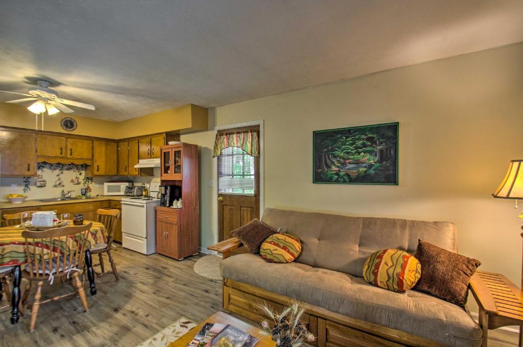 a living room with a couch and a kitchen at Quaint Hinton Hideaway - Hunt and Fish Nearby! in Hinton