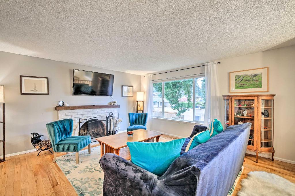 a living room with a couch and a table at Spacious Kent Getaway with Yard, Deck and Grill! in Kent