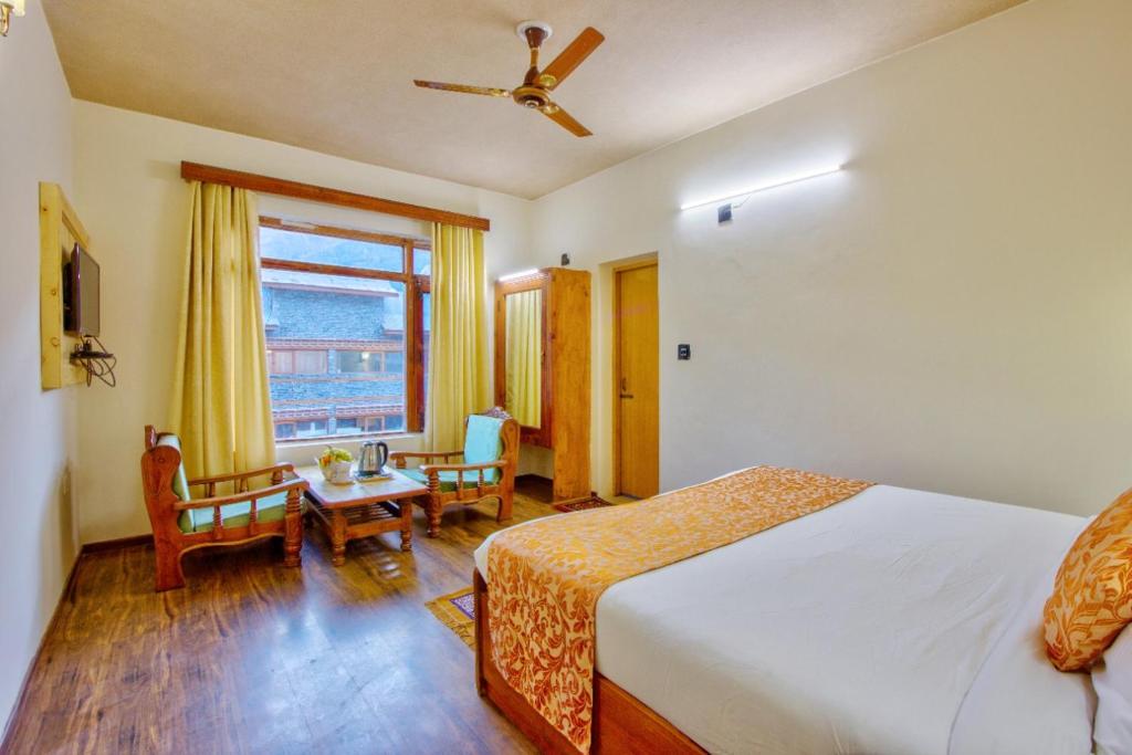 Postel nebo postele na pokoji v ubytování Ayushman Hotels