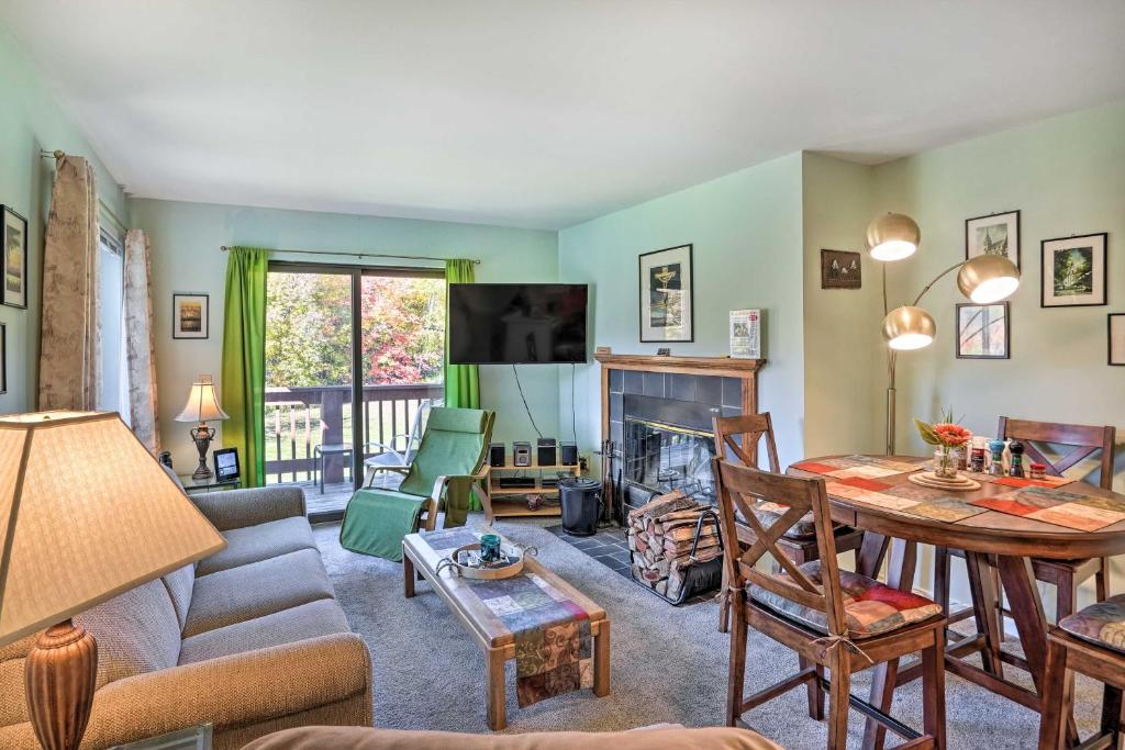 a living room with a couch and a table at Comfortable Dover Apartment Walk to Mt Snow! in Dover