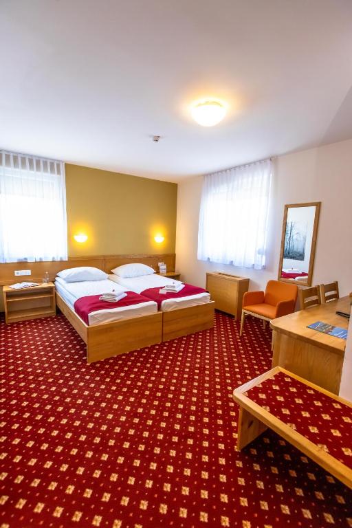 Postel nebo postele na pokoji v ubytování Hotel Bau Maribor