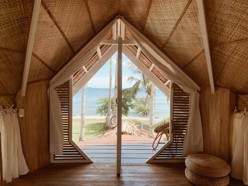 a room with a large window with a view of the ocean at Punta Punta Surf Retreat in General Luna