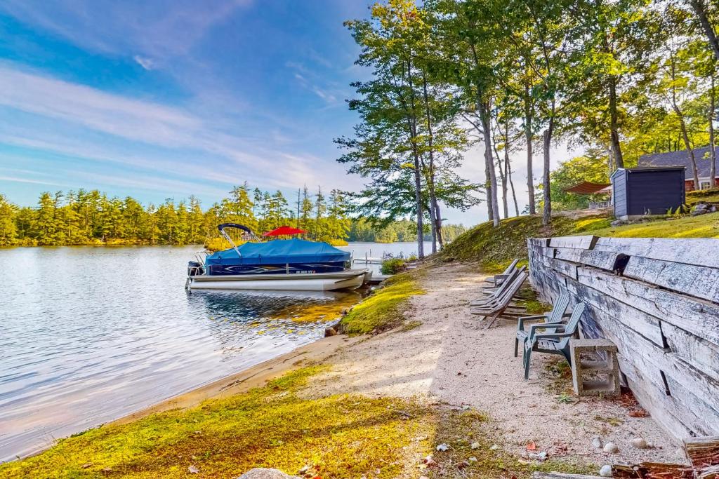 a boat parked on the shore of a lake at Marwood Lake Cottage in Wakefield