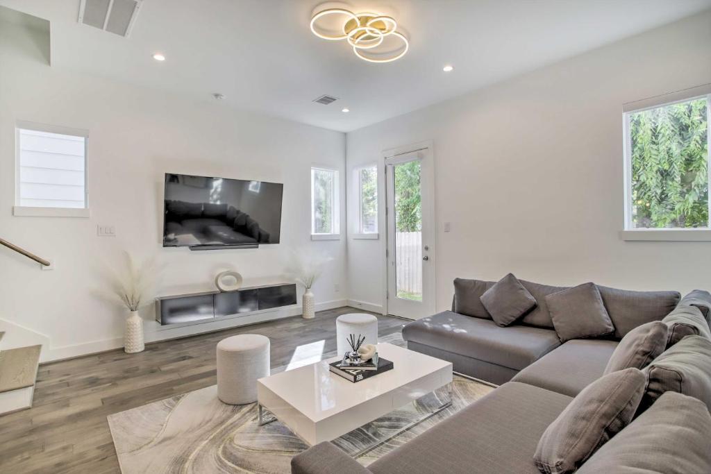 a living room with a couch and a tv at Newly-Built Luxury Galleria Area Townhome! in Houston