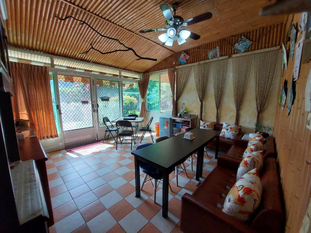 a living room with a couch and a table at Gengmengyuan B&amp;B in Xikou