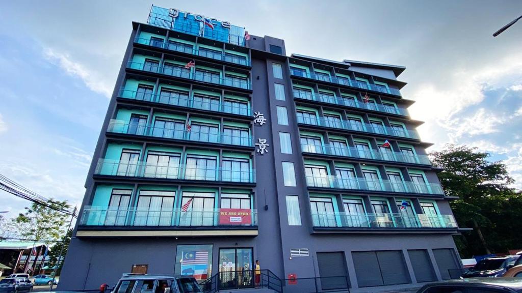 a tall building with many windows on a street at Grace Samudera Hotel in Semporna