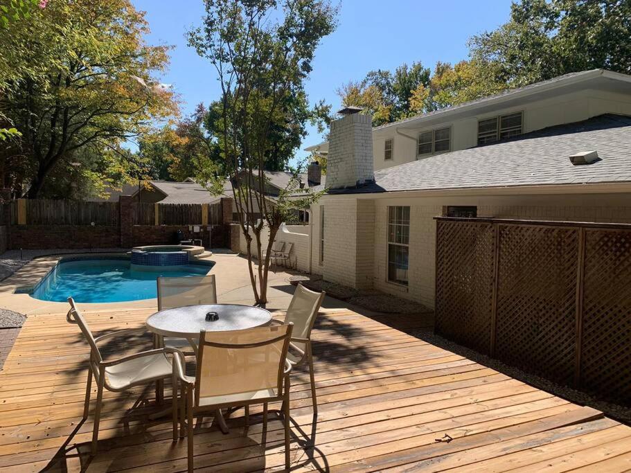 a patio with a table and chairs next to a pool at Large Southern Home with Swimming Pool, 5 king bed in Memphis
