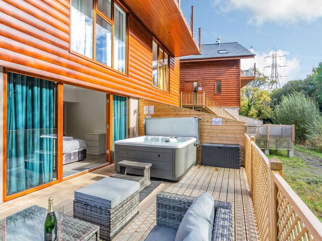 a deck with a hot tub on a house at Waterside Lodge Six - Uk38264 in Southowram