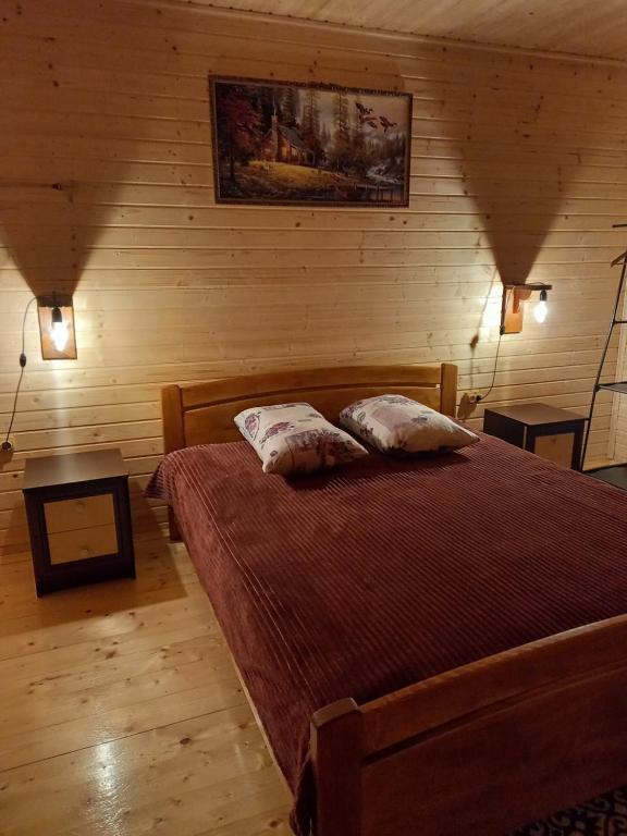 a bedroom with a bed with two pillows on it at Котедж "Затишний відпочинок" in Huklyvyy