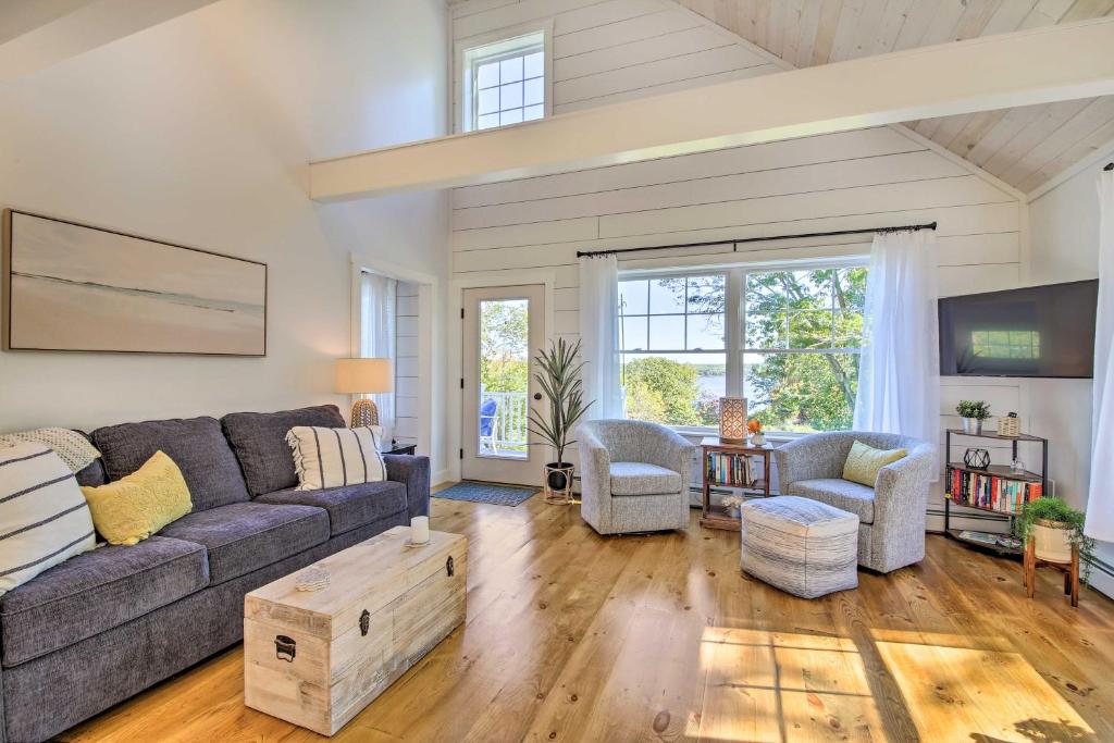 a living room with a couch and a table at Sunny Stockton Springs Home Less Than 1 Mi to Beach! in Stockton Springs