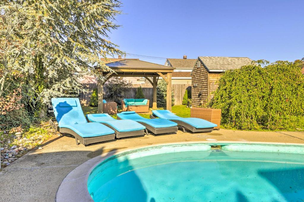 a swimming pool with lounge chairs and a gazebo at New Haven Gem with Private Pool, Walk to Beach! in New Haven