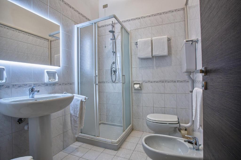 a bathroom with a sink and a toilet and a shower at Hotel Calypso in Ventimiglia