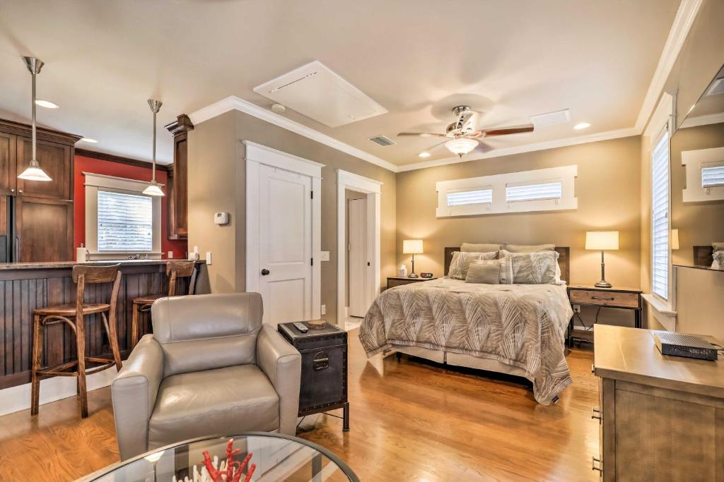 a bedroom with a bed and a chair and a kitchen at Hyde Park Luxury Studio with Prime Location! in Tampa