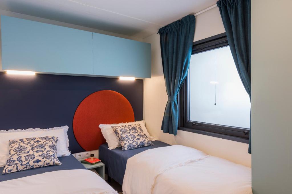 Een bed of bedden in een kamer bij Fornella Camping & Wellness family resort