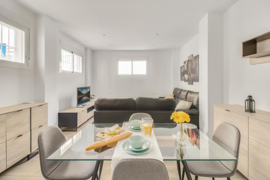 a living room with a glass table and chairs at MILLION APARTAMENT in Málaga