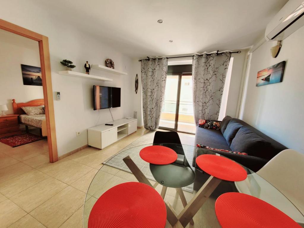 a living room with a couch and a table and chairs at Apartament Lloret de Mar with terrace in Lloret de Mar