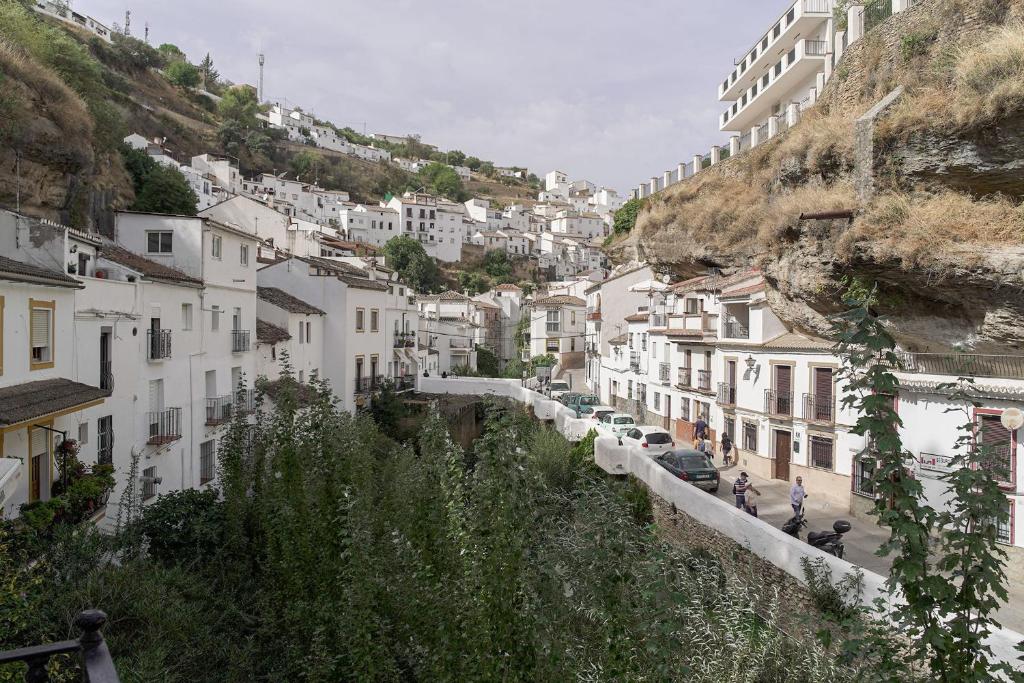 a view of a city with buildings on a mountain at Casa Rural Las Cuevas de Setenil in Setenil