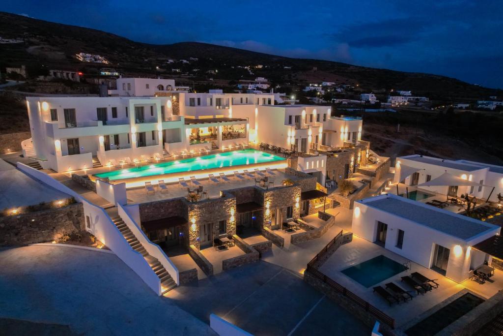an aerial view of a building with a pool at night at Kouros Blanc Resort & Suites in Pounda