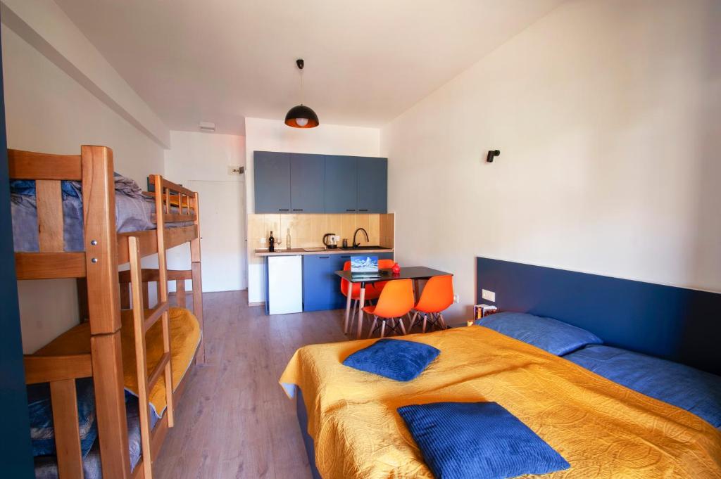 a bedroom with a bunk bed and a kitchen at Gudauri Smart Apartment in Gudauri