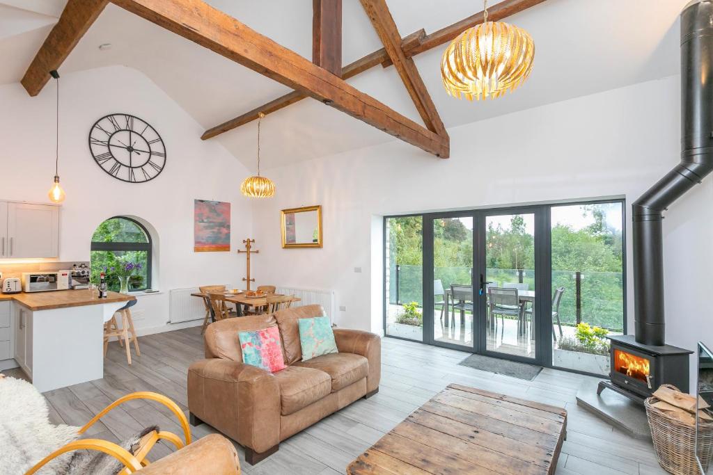 a living room with a couch and a stove at Riverbank Cottage in Lancaster