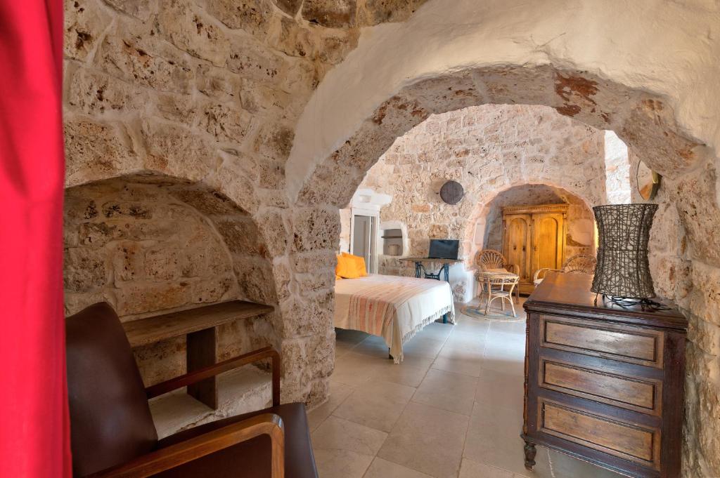 A bed or beds in a room at Trullo Cezanne sustainable and peaceful
