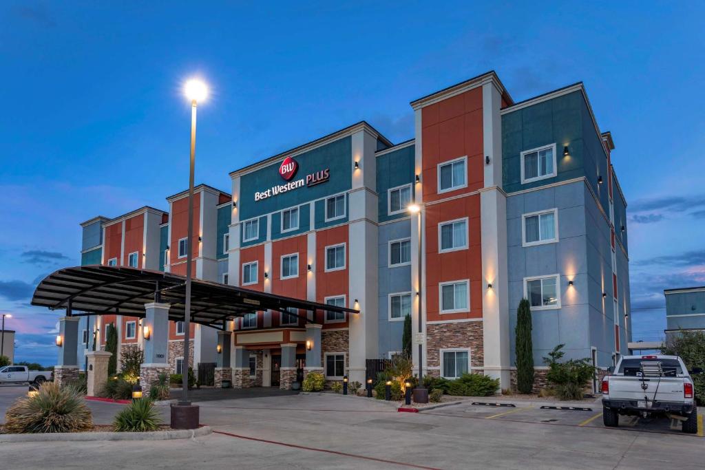 a hotel with a truck parked in a parking lot at Best Western Plus North Odessa Inn & Suites in Odessa