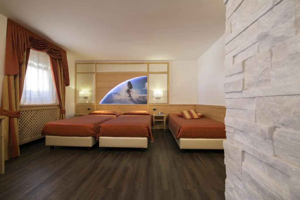 Postel nebo postele na pokoji v ubytování Hotel Touring