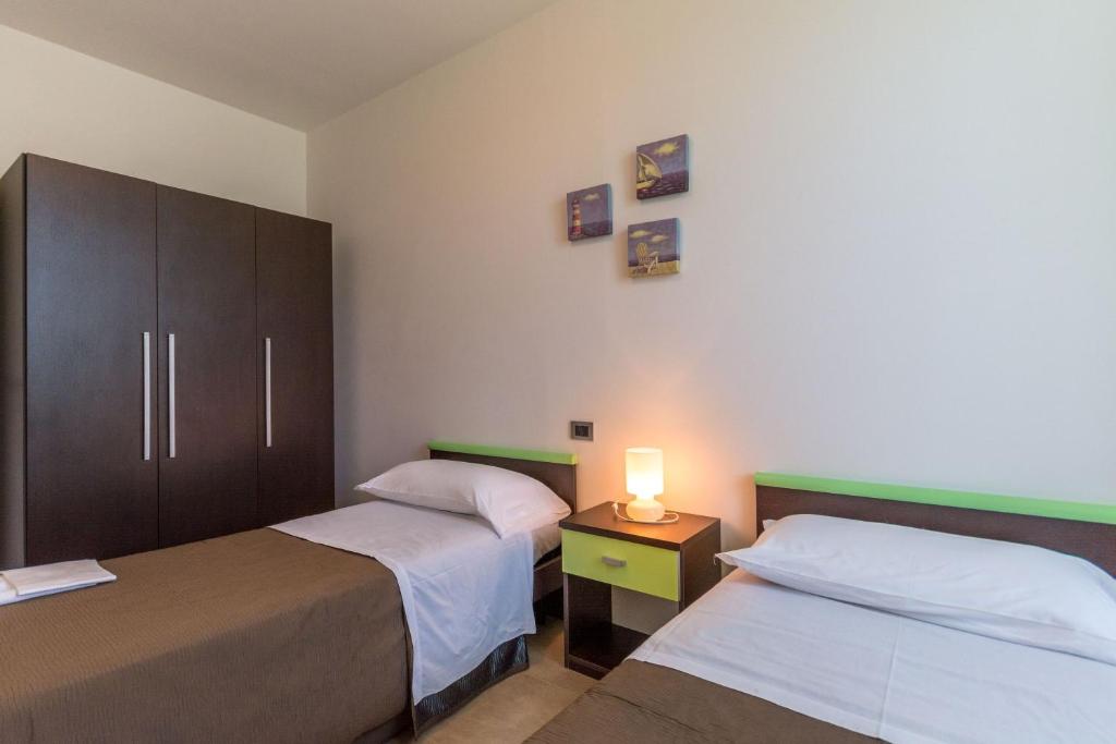 Postel nebo postele na pokoji v ubytování Residence Albarella