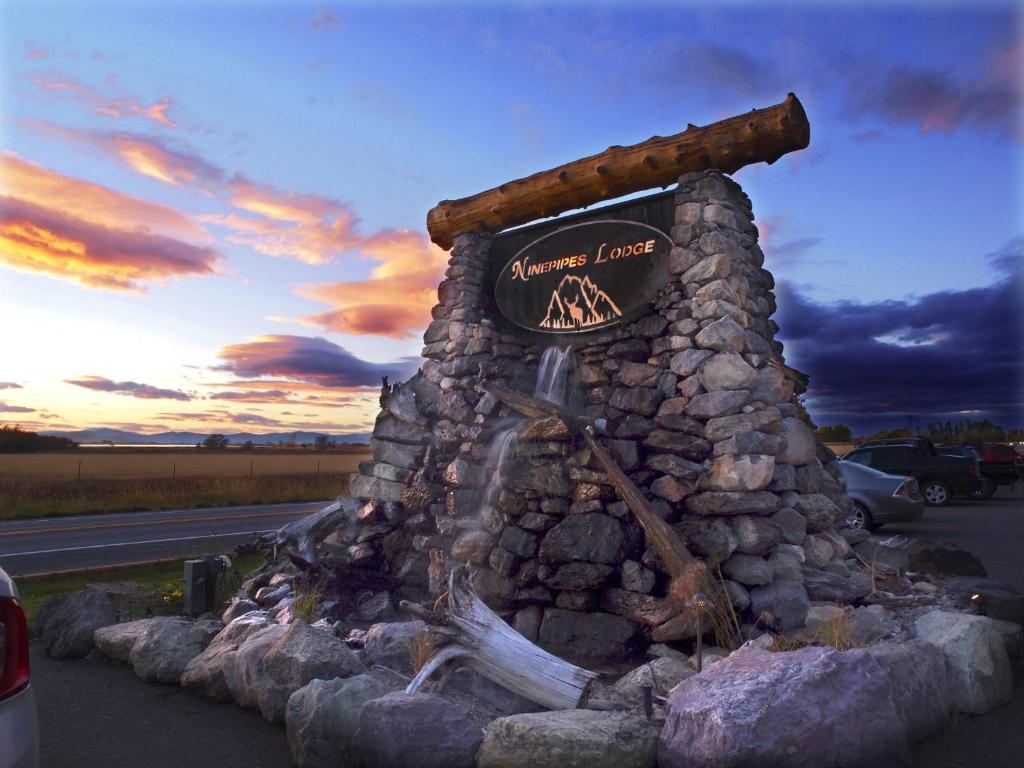 a sign for a restaurant on the side of a road at Ninepipes Lodge in Polson