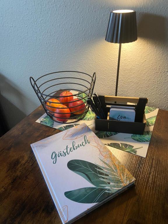 a table with a basket of fruit and a sign on it at Lagerhaus Gabriel in Zweibrücken