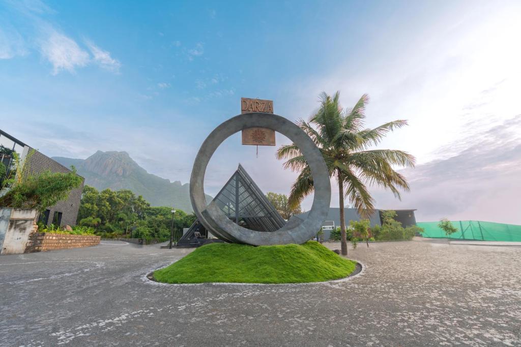 a large metal sculpture on a patch of grass at DARZA LUXURY RESORTs in Coimbatore