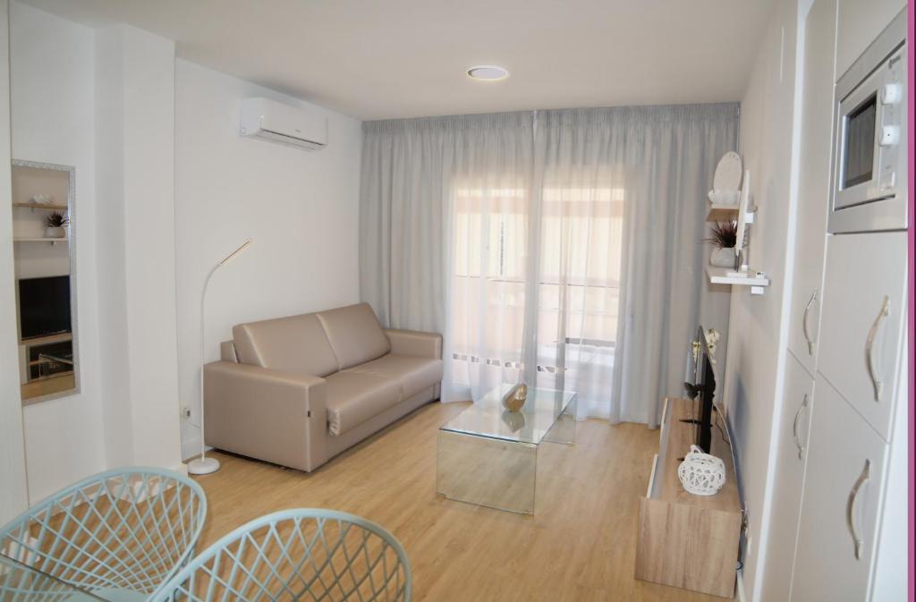 a living room with a couch and a table at Leo Canela in Isla Canela