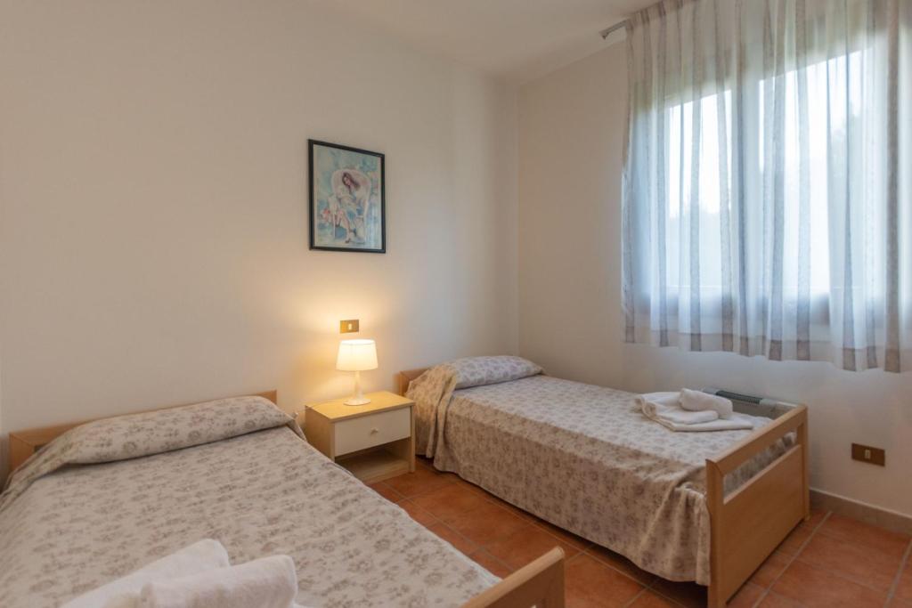 Postel nebo postele na pokoji v ubytování Residence Albarella