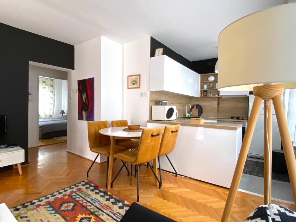 a kitchen and dining room with a table and chairs at Layla's Home Free Parking in Sarajevo