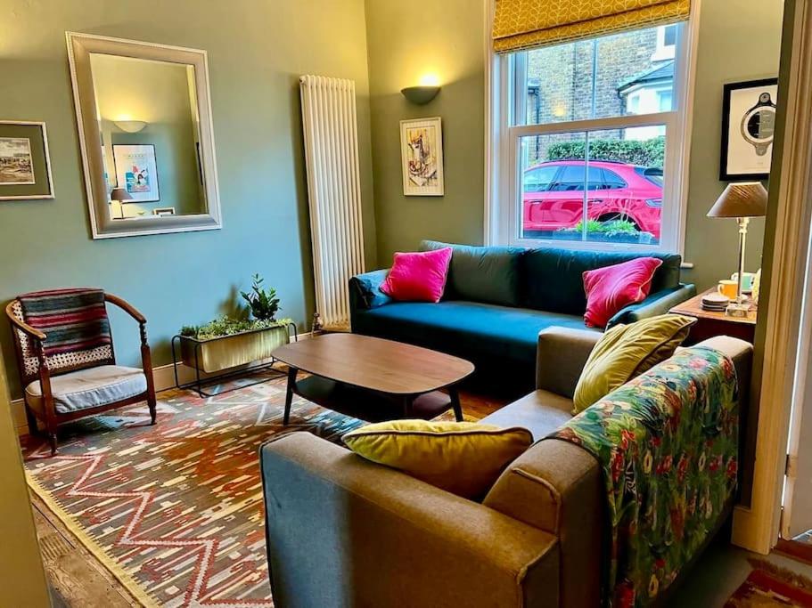 a living room with a couch and a table at Holbrook House in Kent