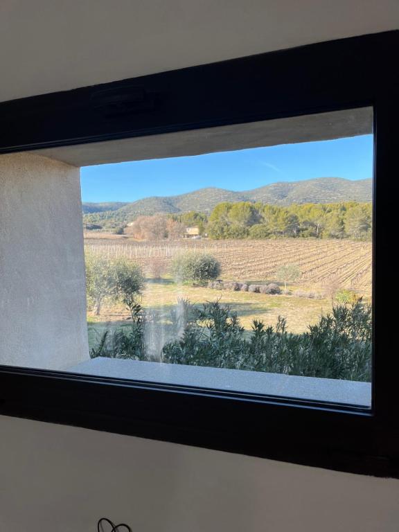 a window in a room with a view of a field at Appartement st Victor in Puyvert