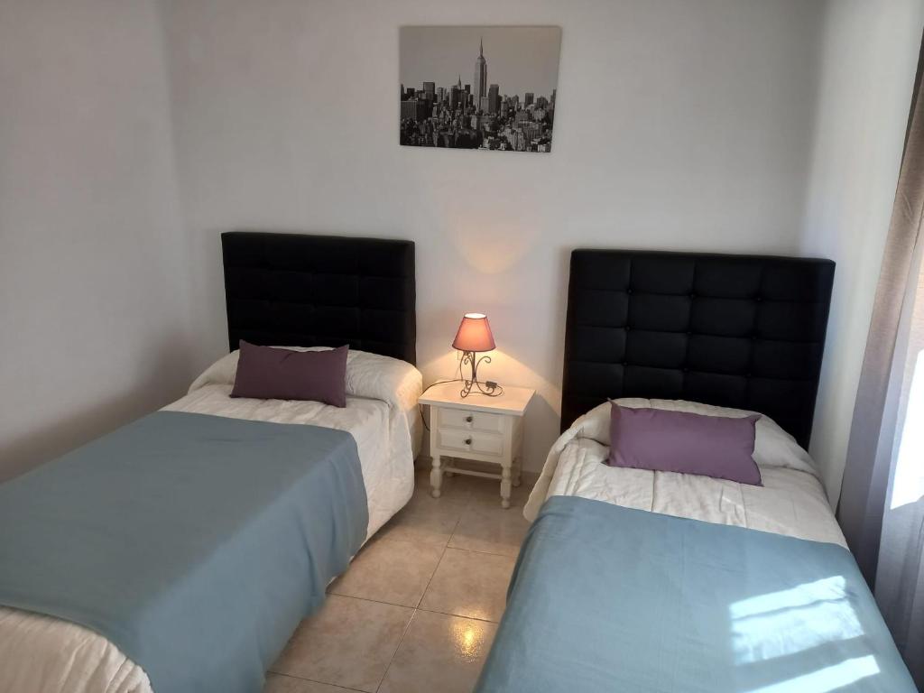 Łóżko lub łóżka w pokoju w obiekcie Centric apartment in Malaga