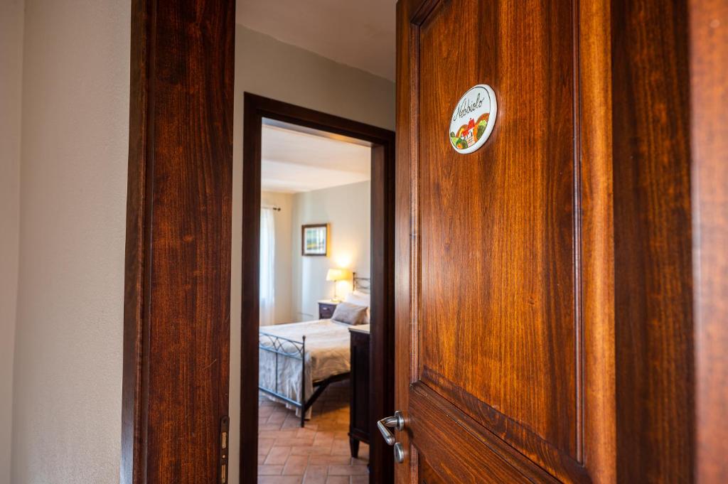 uma porta para um quarto com um quarto e uma cama em CONVINO em Castiglione Falletto