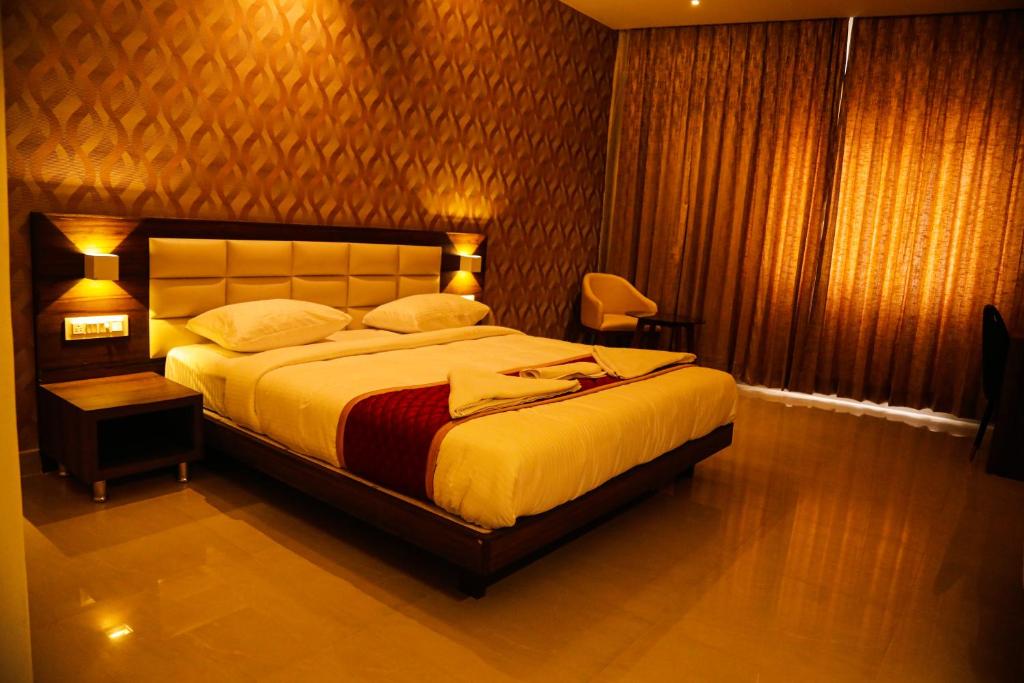 a bedroom with a large bed in a room at Royal Indraprastha The Hotel in Bengaluru