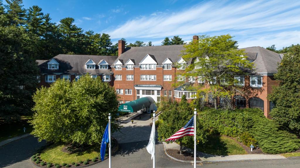 uma vista aérea de uma casa com bandeiras à sua frente em The Simsbury Inn em Simsbury