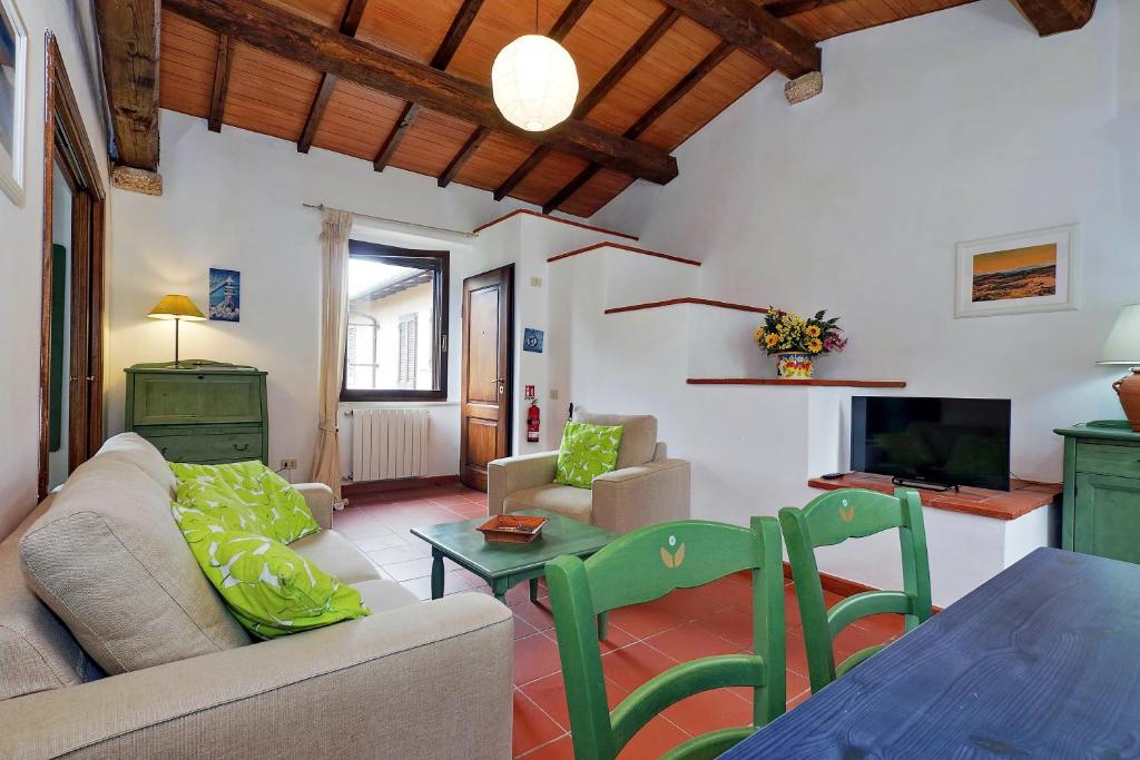 a living room with a couch and a table at Agriturismo Pimpinnacolo in Porto Ercole