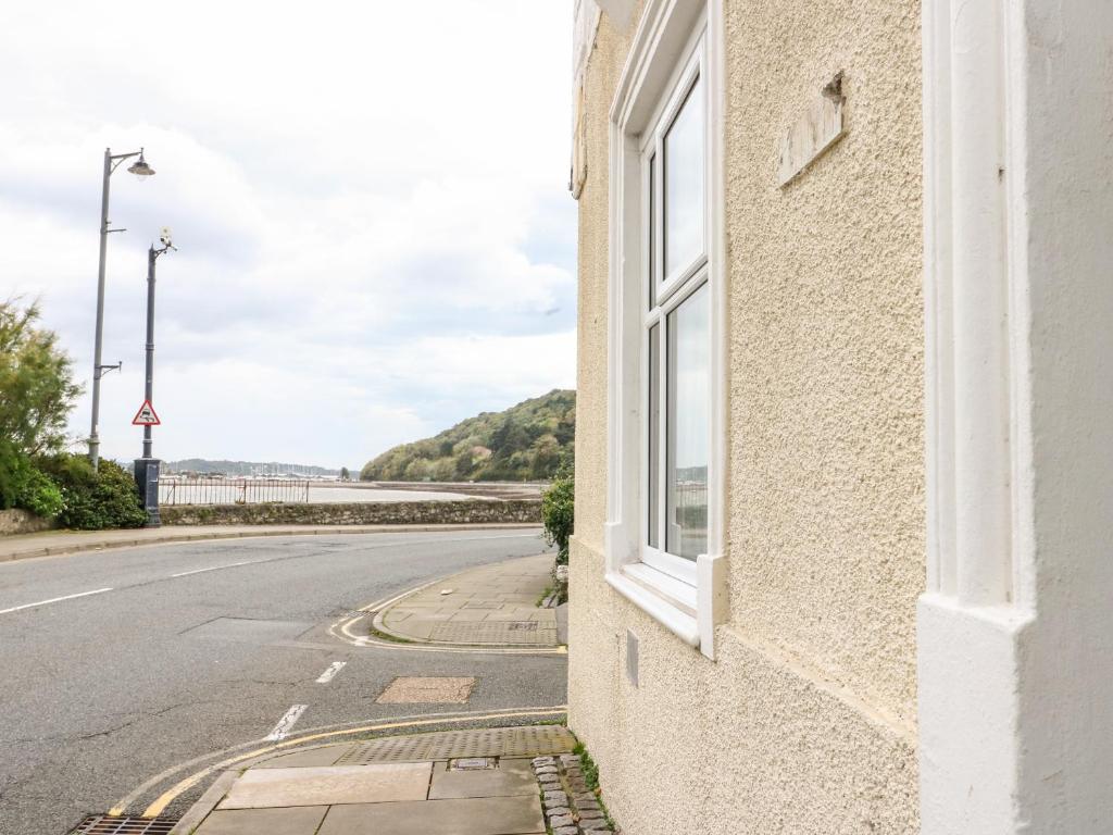 a building with a window on the side of a road at Gadlys House 62 in Beaumaris