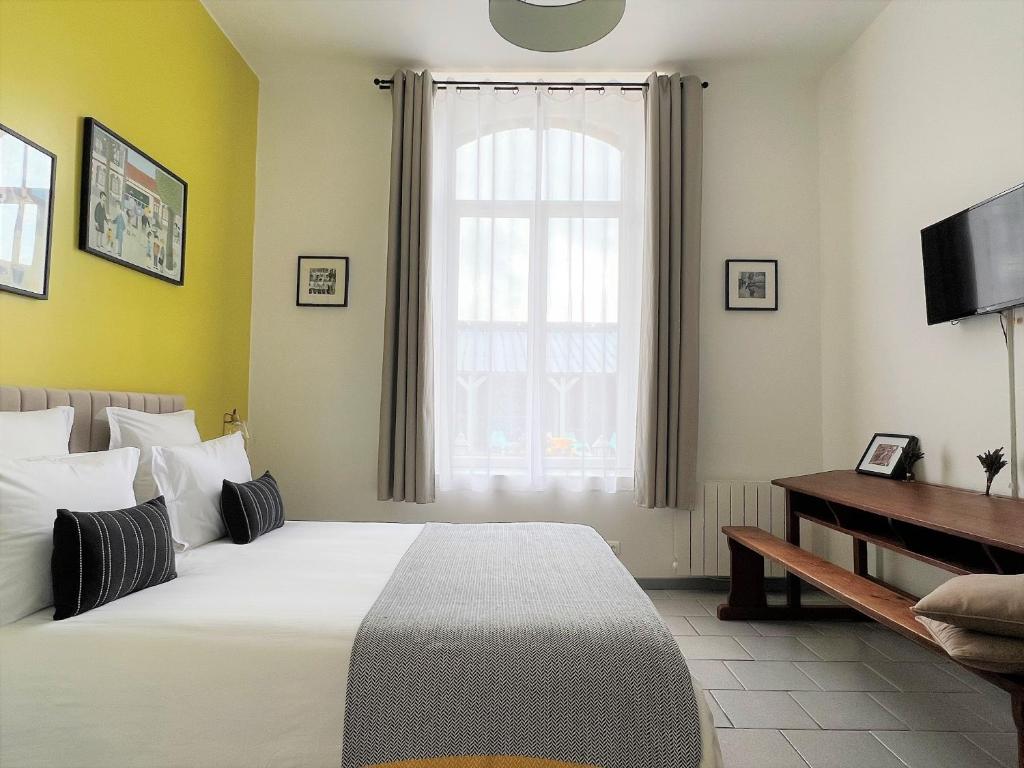 Postel nebo postele na pokoji v ubytování La Récréation - Chambres et Appartements