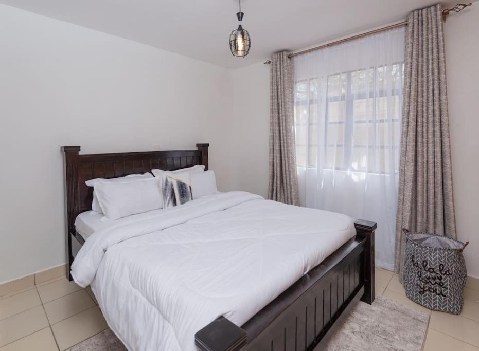 Postel nebo postele na pokoji v ubytování Athi Luxury Suites
