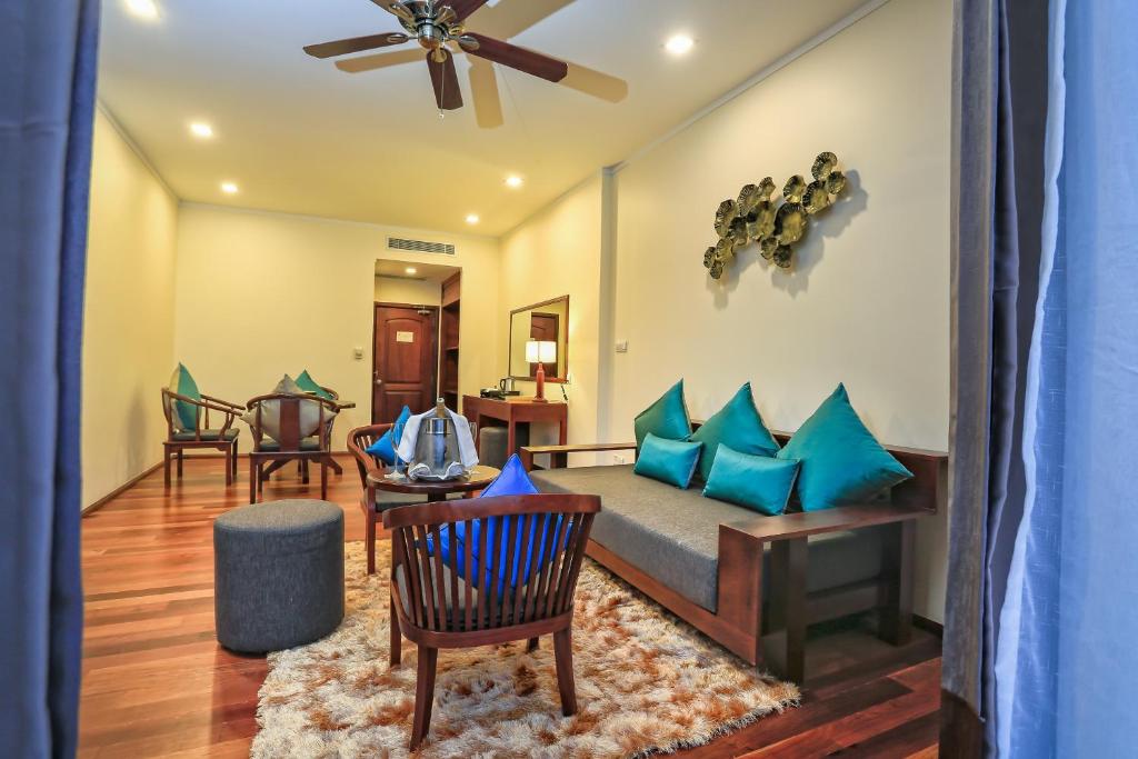 a living room with a couch and a table at Lotus Blanc Resort in Siem Reap