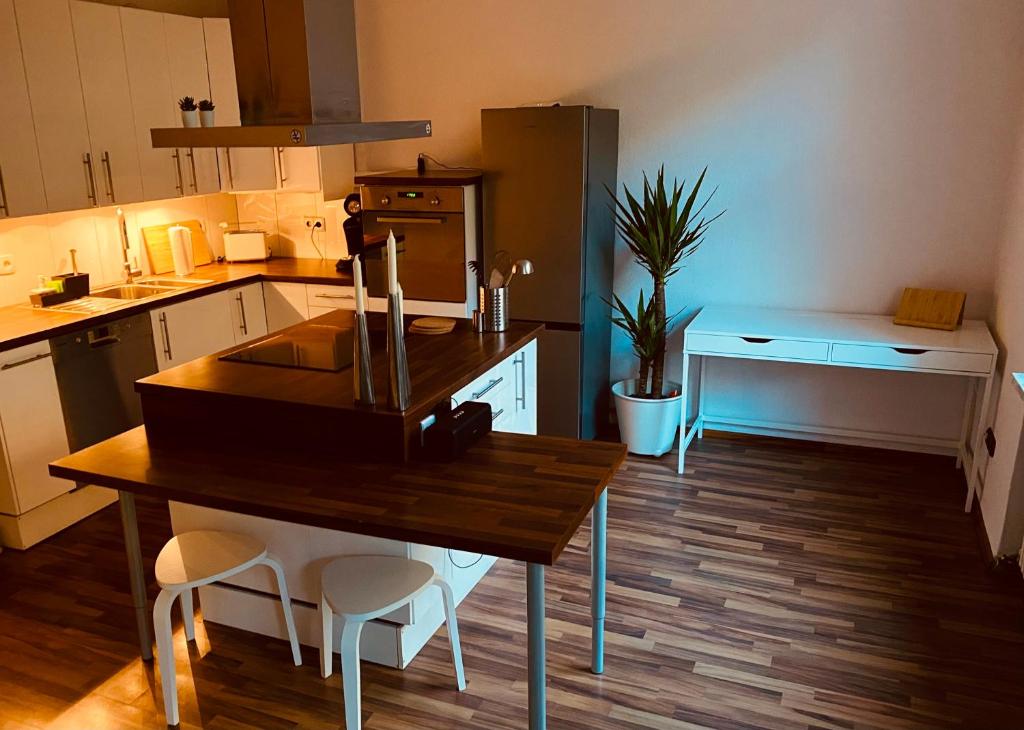a kitchen with a wooden table and chairs in it at Tolle Stadtwohnung mit guter Verkehrsanbindung Von der Goltz 35 in Dortmund