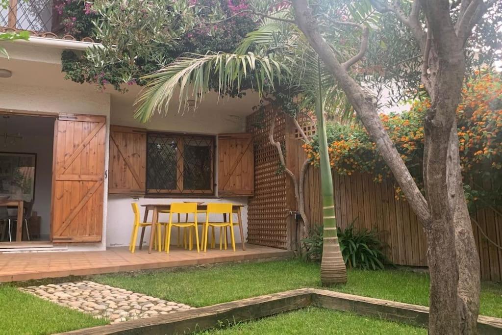 a house with a table and chairs in a yard at Mediterranean house, pool, beach and charm garden in Arenys de Mar