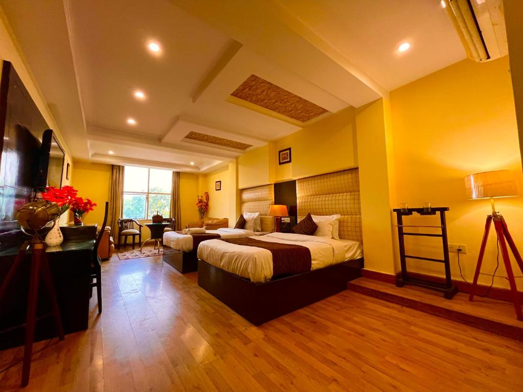 a hotel room with a bed and a desk at Reo Resort, near bus stand & railway station ,Haridwar in Haridwār